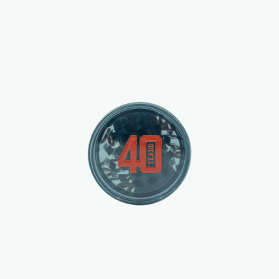 The Coffeeshops 40 Years Collectible Grinder showing a sleek metal grinder with engraved branding and a compact design.