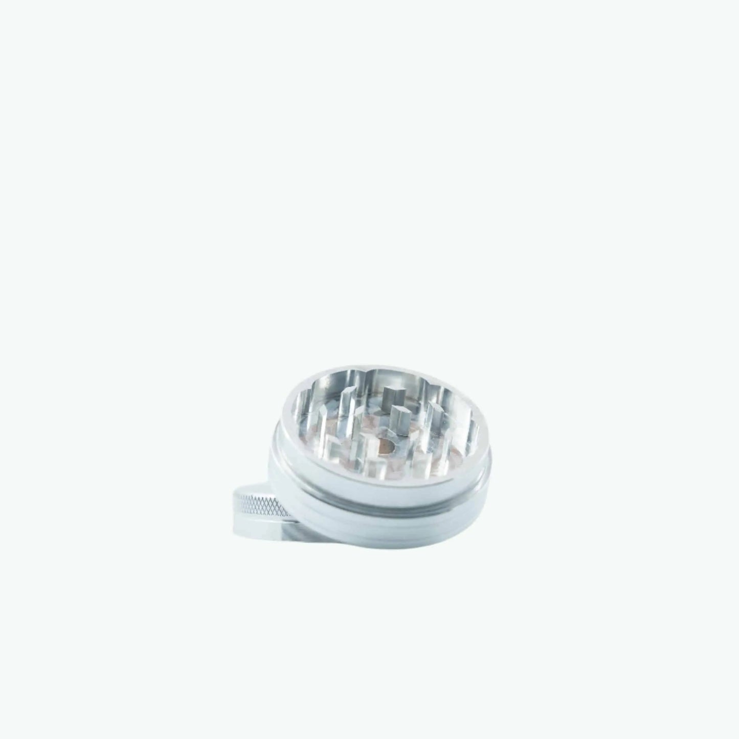 Silver metal grinder by The Coffeeshops with textured surface and sturdy build, ideal for grinding herbs or spices.